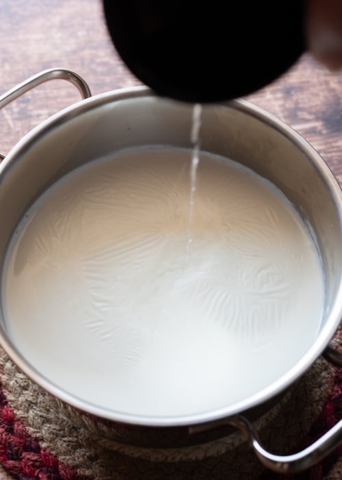 The hot milk and adding the lemon juice.