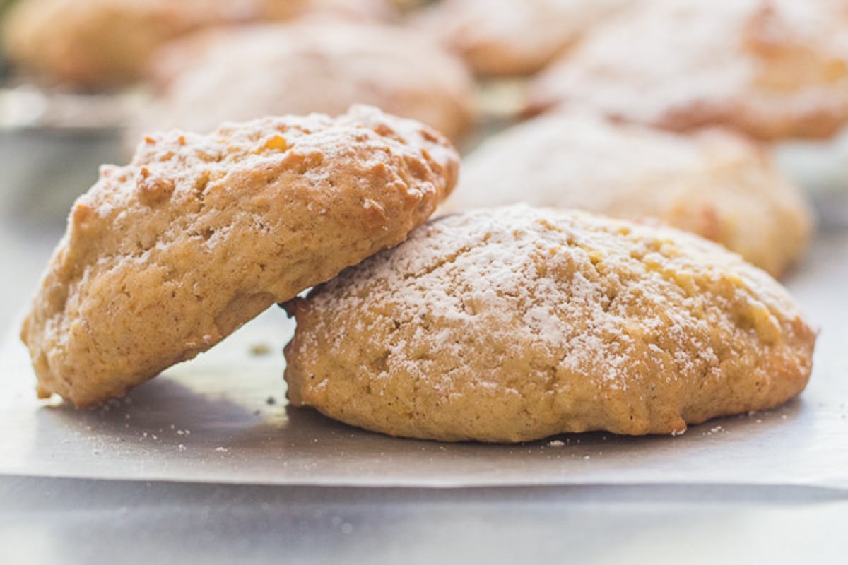 Two applesauce cookies on waxed paper.