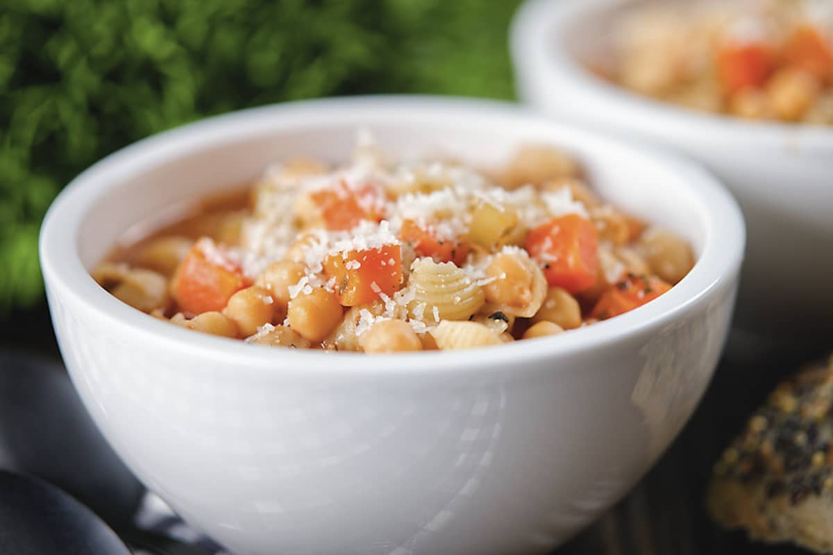 Chickpea soup in a white bowl.