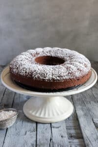 Yogurt cake on a white cake stand.