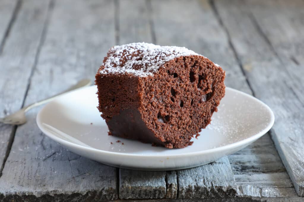 A slice of cake on a white plate.