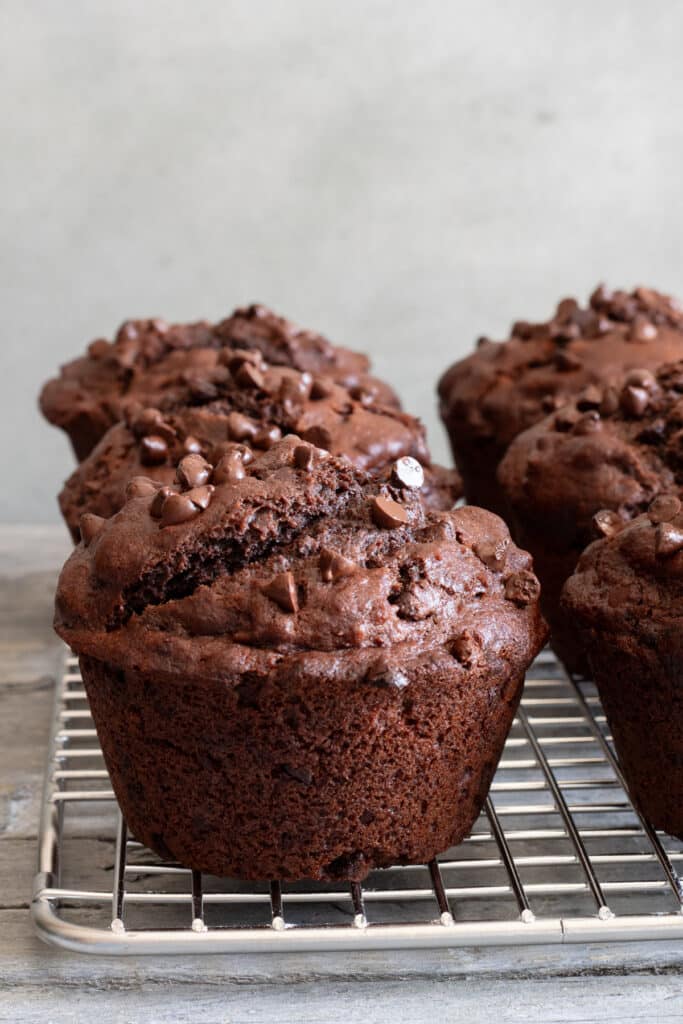 Chocolate muffins on a wire rack.