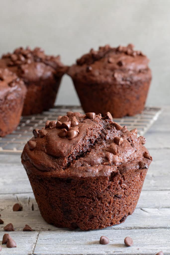 Muffin up close and three on a wire rack.