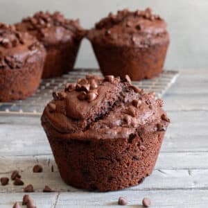 Muffin up close and three on a wire rack.