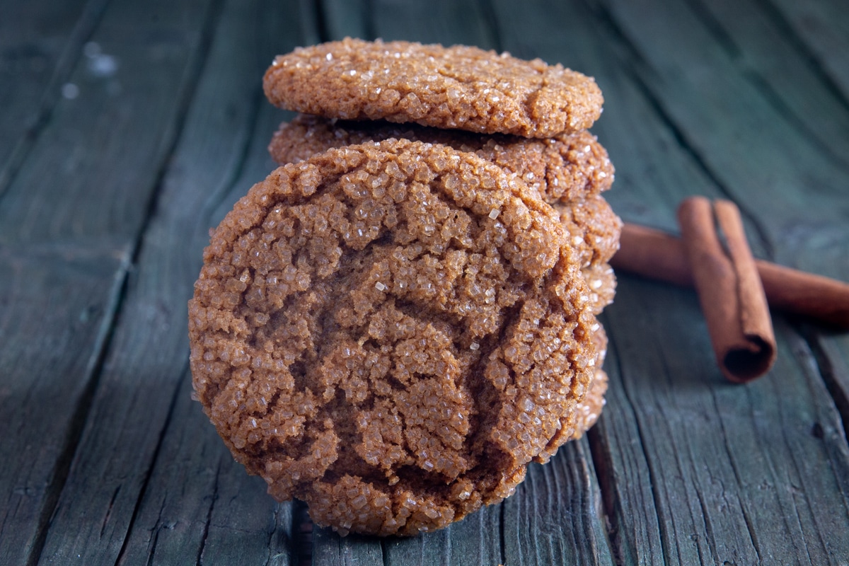 Ginger cookies stacked with a cookie leaning against it.