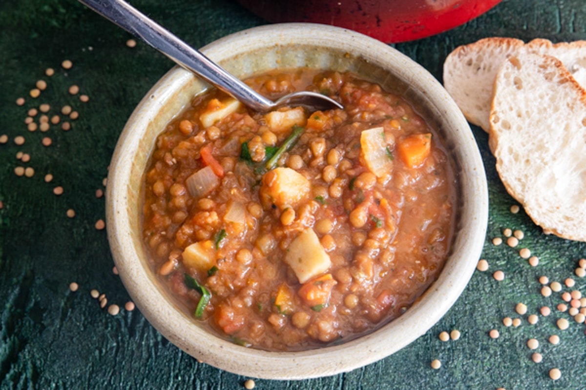 Lentil soup in a white bowl.