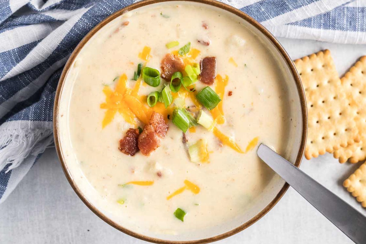 Potato soup in a white bowl.