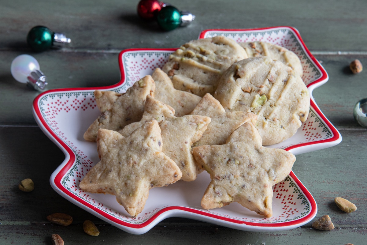 Pistachio shortbread cookies on a tree shaped plate.