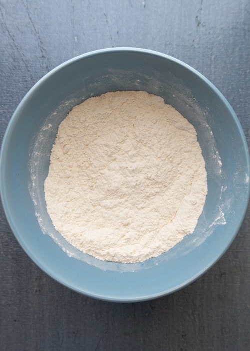 The dry ingredients whisked in a blue bowl.