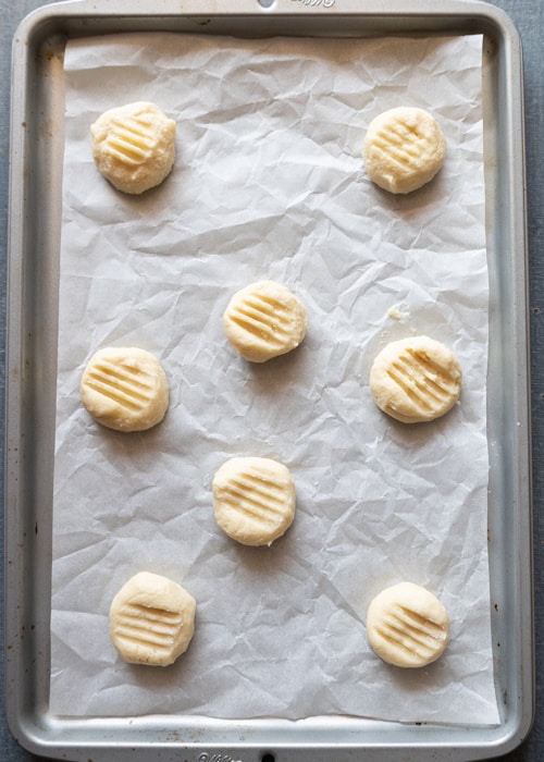 The almond cookies before baked on the prepared baking sheet.