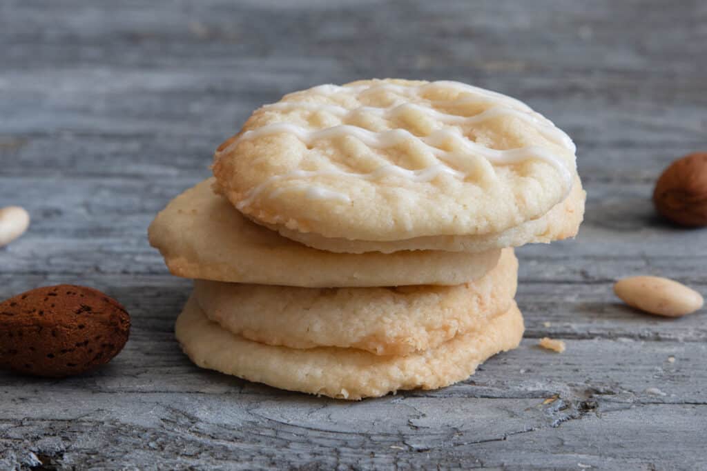 Four almond butter cookies stacked.