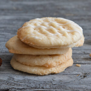 Four almond butter cookies stacked.