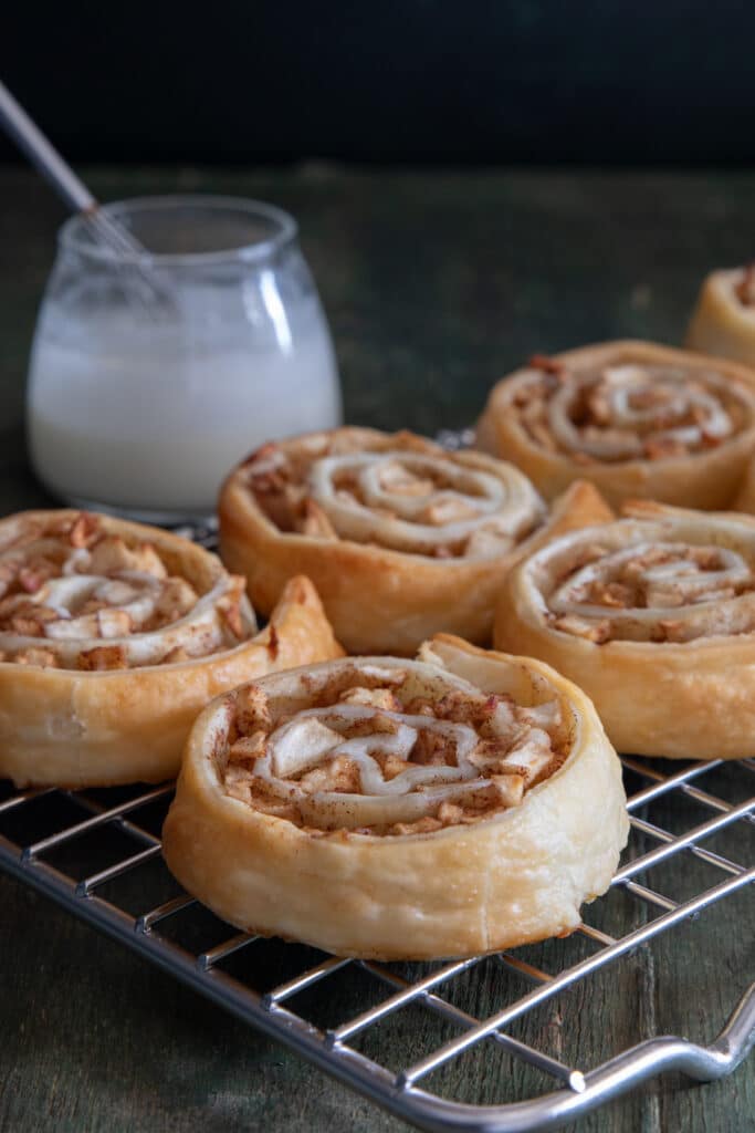 The apple roll ups on a wire rack.