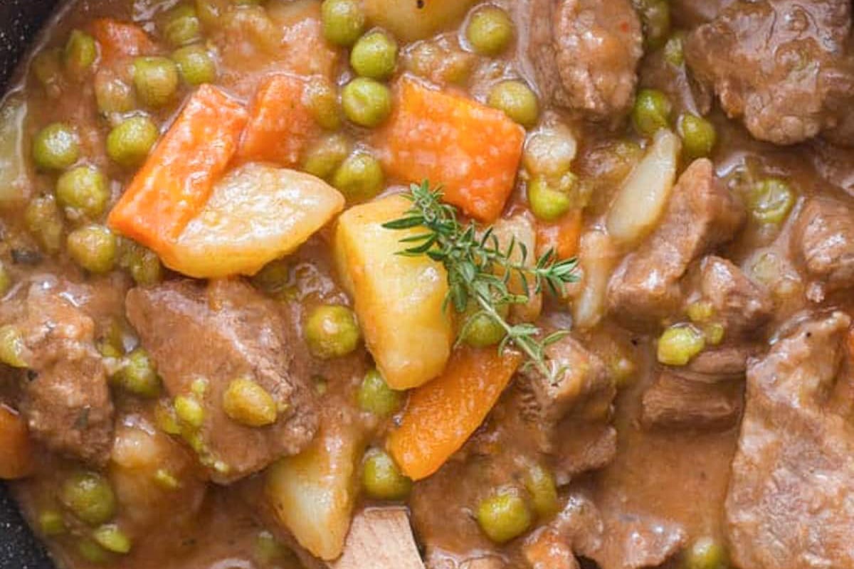 Beef stew in a black pot.