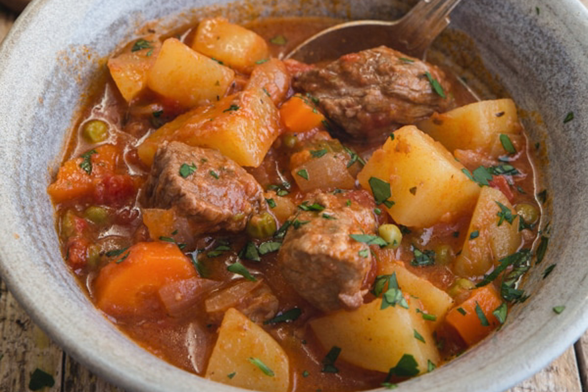 Baked beef stew in a grey bowl.