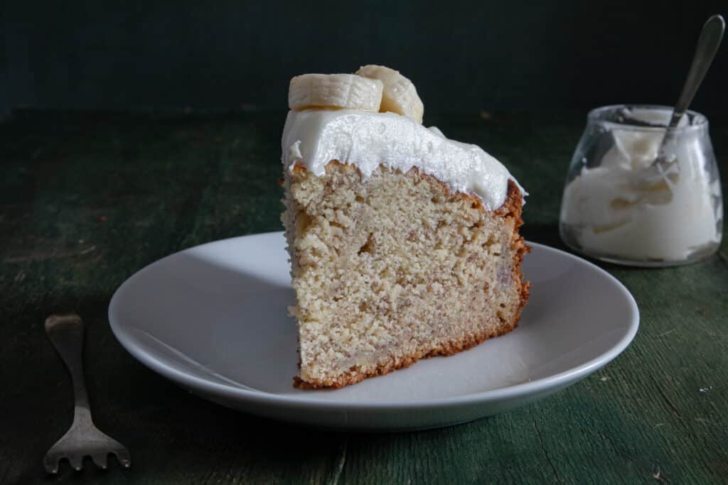 A slice of cake on a white plate.