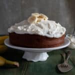 Banana cake on a white cake stand.