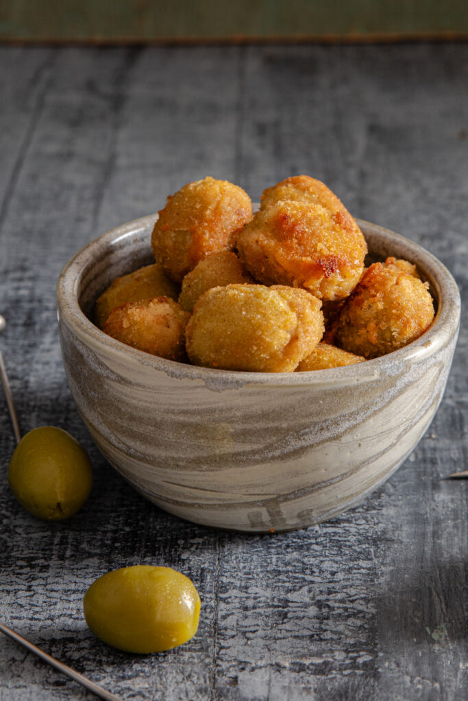 Olives in a grey bowl.