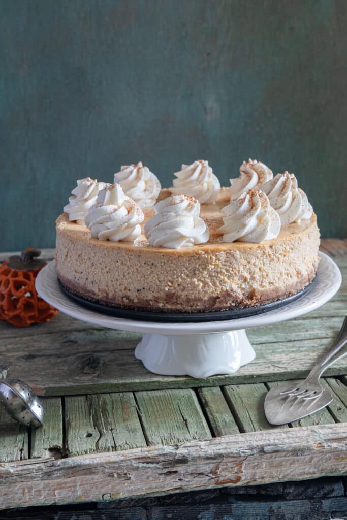 Pumpkin cheesecake on a white plate.