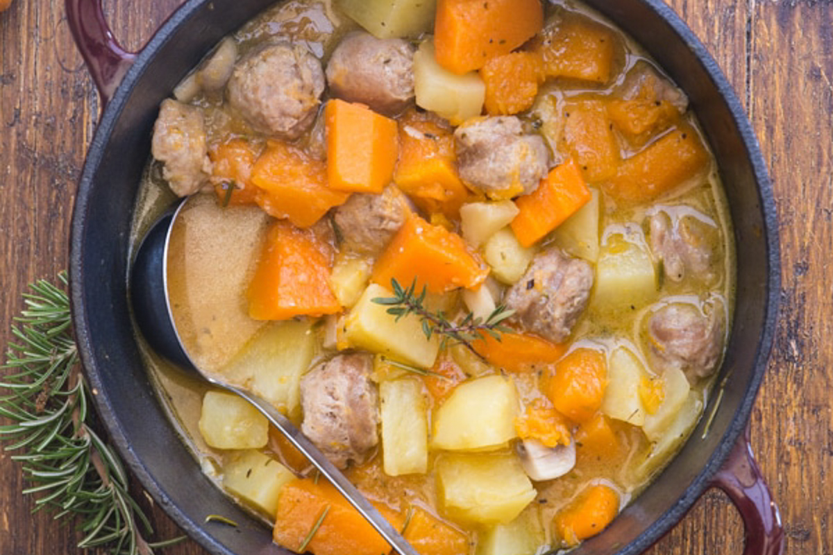 Pumpkin stew in a black pot.