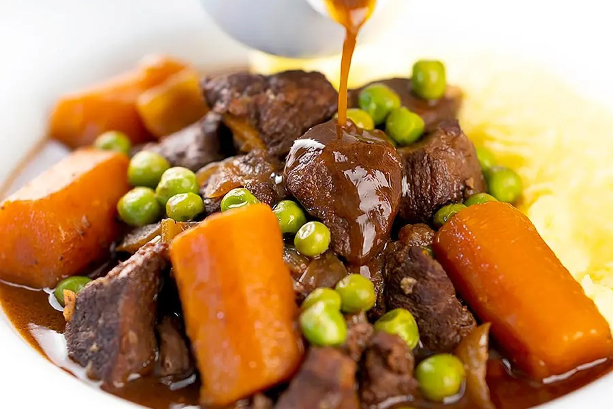 Venison stew in a white bowl.