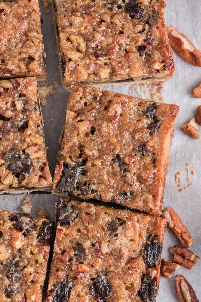 Butter tart squares cut on parchment paper.