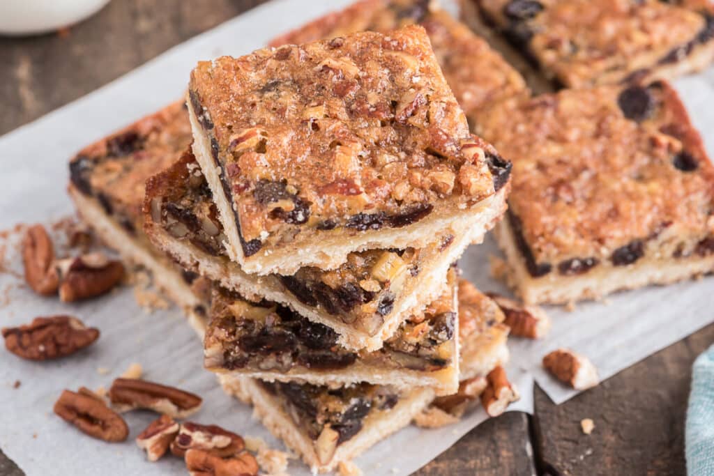 Cookies stacked on parchment paper.