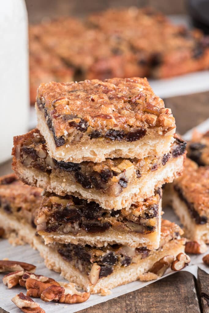 Cookies stacked on parchment paper.