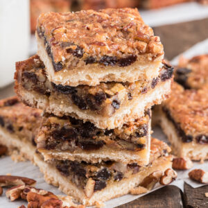 Cookies stacked on parchment paper.