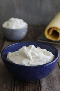 Italian milk cream done two ways in a grey bowl and blue bowl.