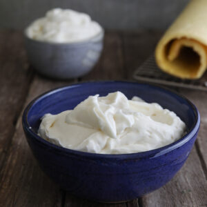 Italian milk cream done two ways in a grey bowl and blue bowl.