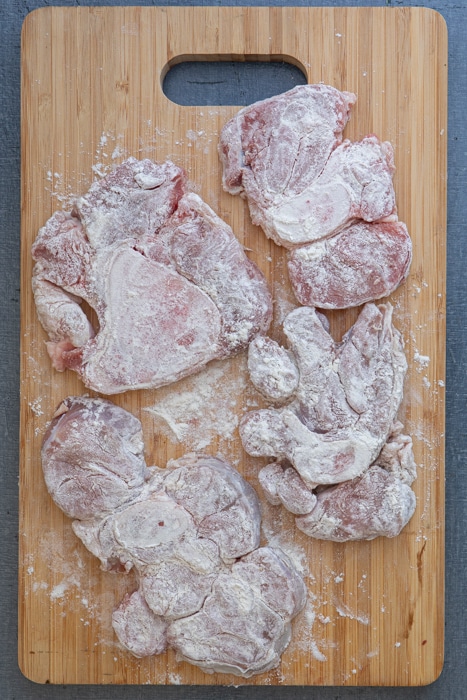 The cut meat on a wooden board.