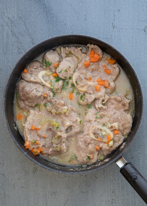 The ossobuco cooked in the pan.