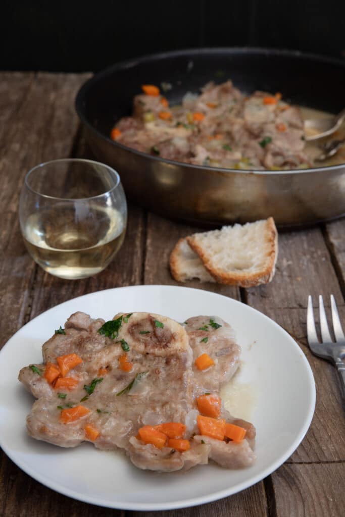 The meat in the pan and one on a white plate.