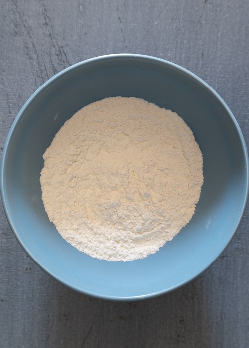 The dry ingredients whisked in a blue bowl.