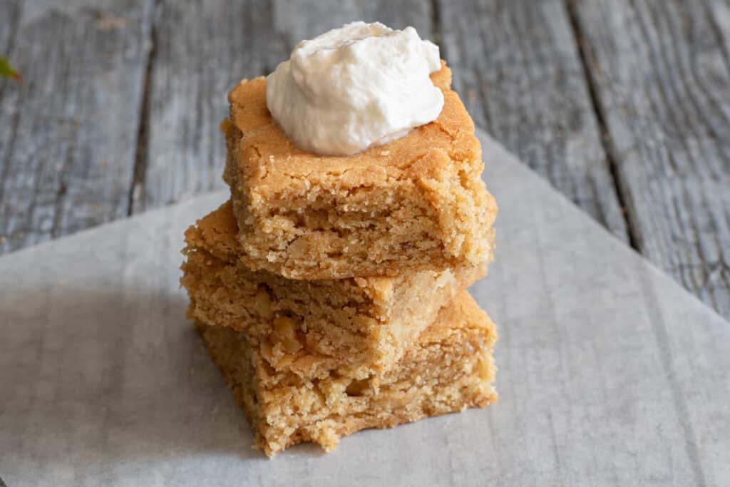 Three bars stacked with a dollop of whipped cream on top of one.