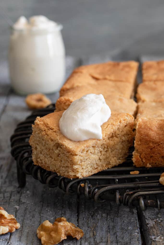 Brown sugar bars with a dollop of whipped cream on one piece.