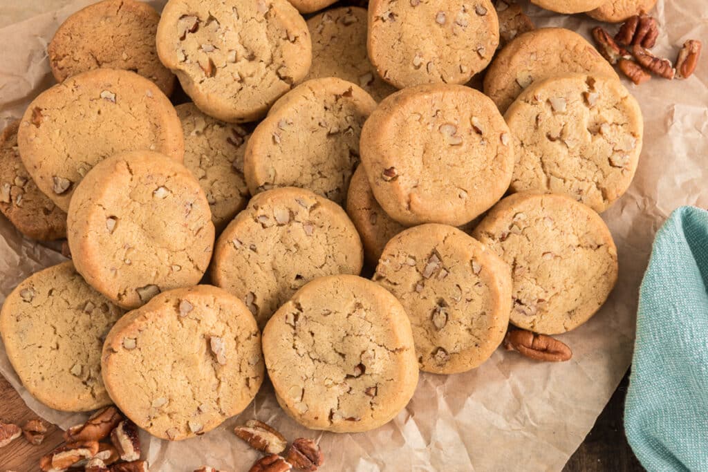 Butter pecan cookies on parchment paper.