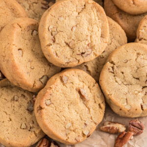 Butter pecan cookies on parchment paper.