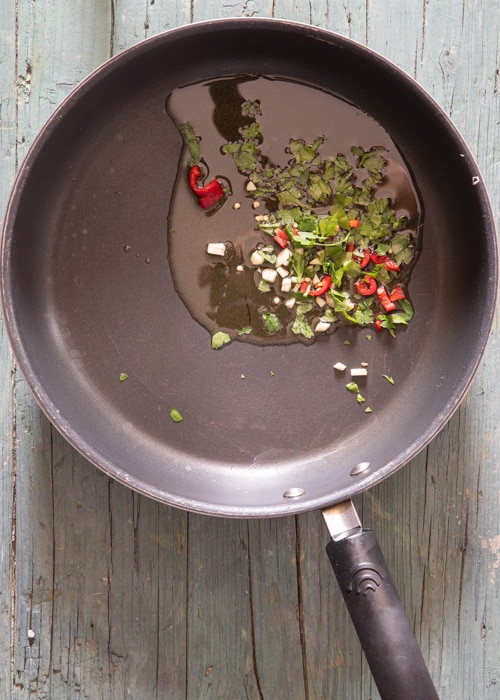 The chopped spices and olive oil in the pan.