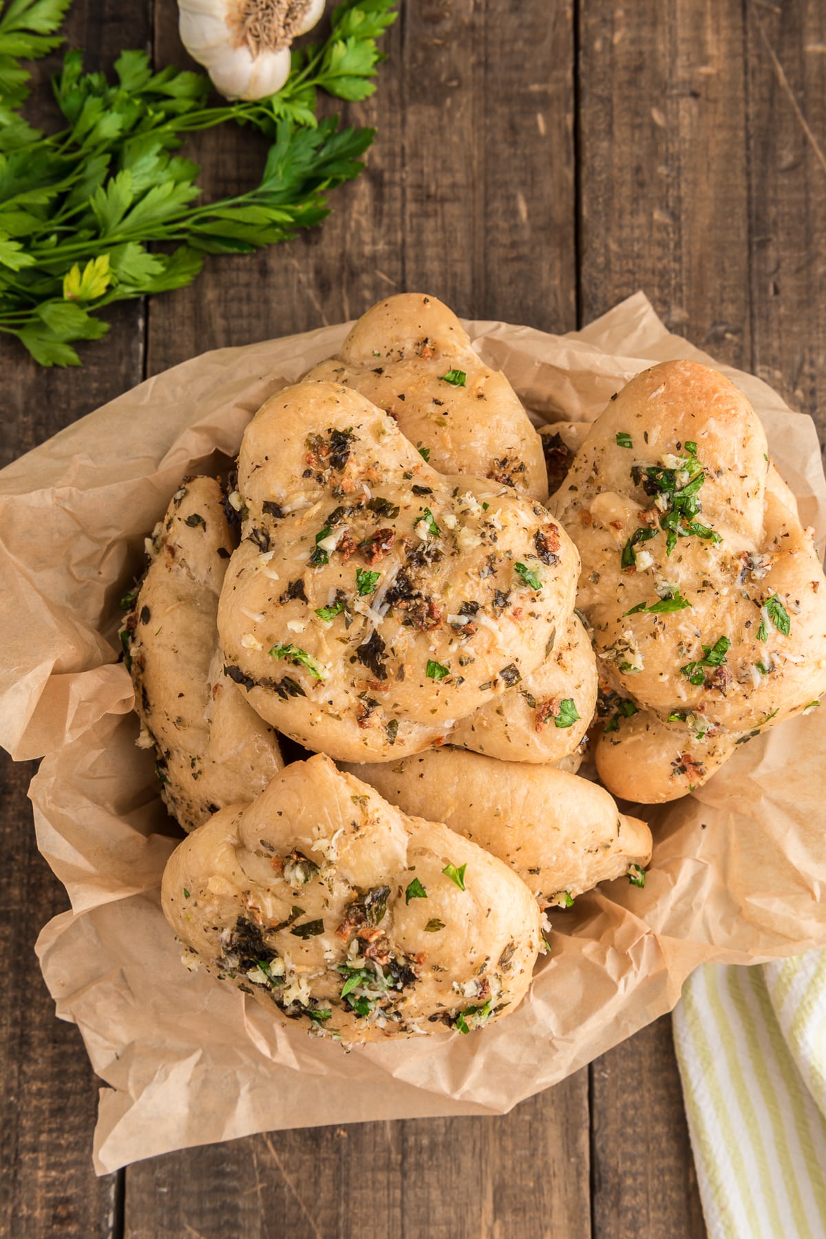 Garlic knots in a basket with paper.