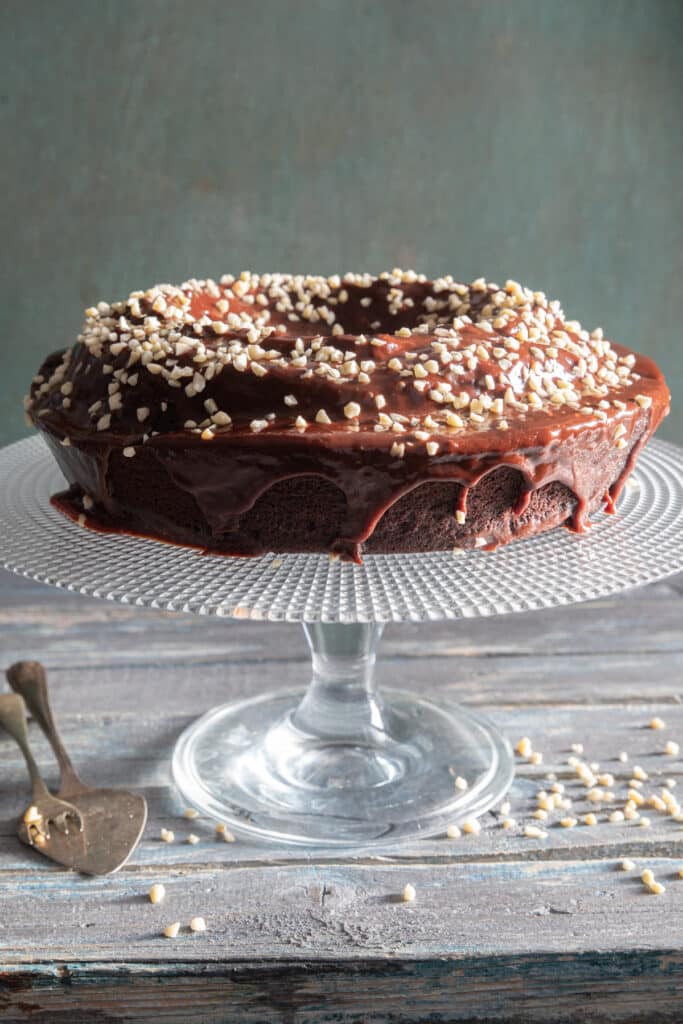 Mocha ricotta cake with a chocolate glaze and chopped nuts.