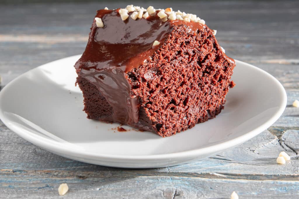 A slice of cake on a white plate.