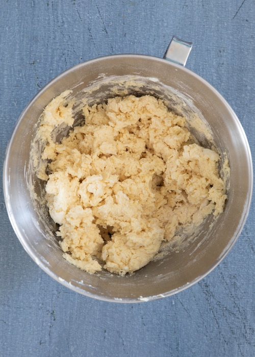 Beating the wet and adding the dry ingredients in the mixing bowl.