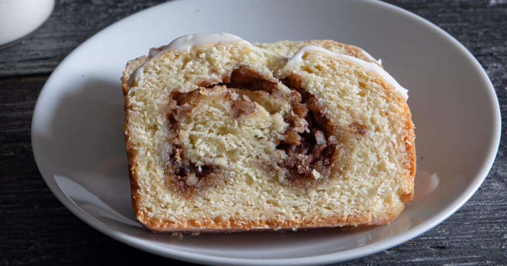 A slice of cinnamon bread on a white plate.