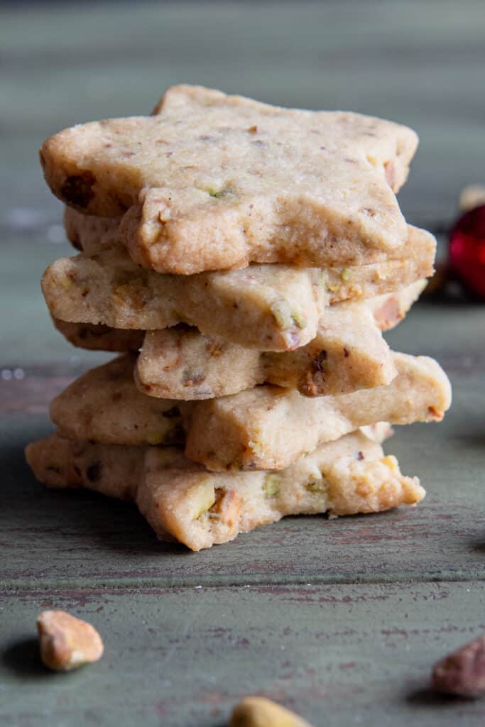 Five pistachio shortbread cookies stacked.