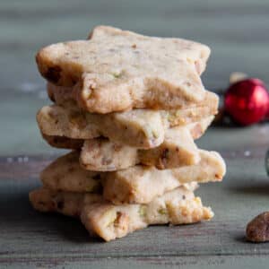 Five pistachio shortbread cookies stacked.