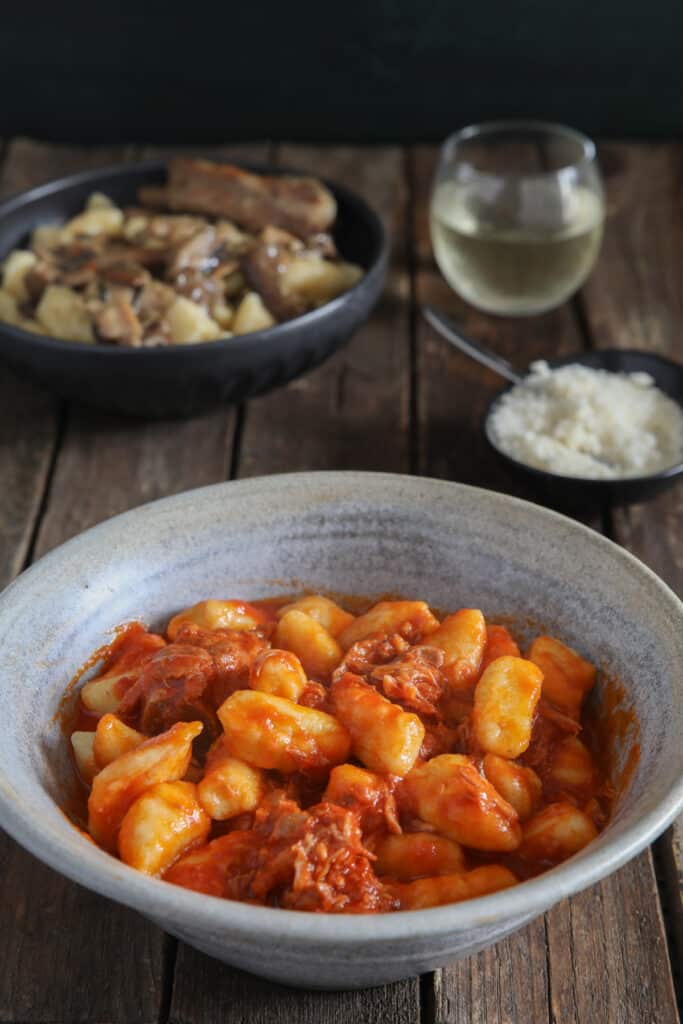 Polenta in a blue bowl and a black bowl.