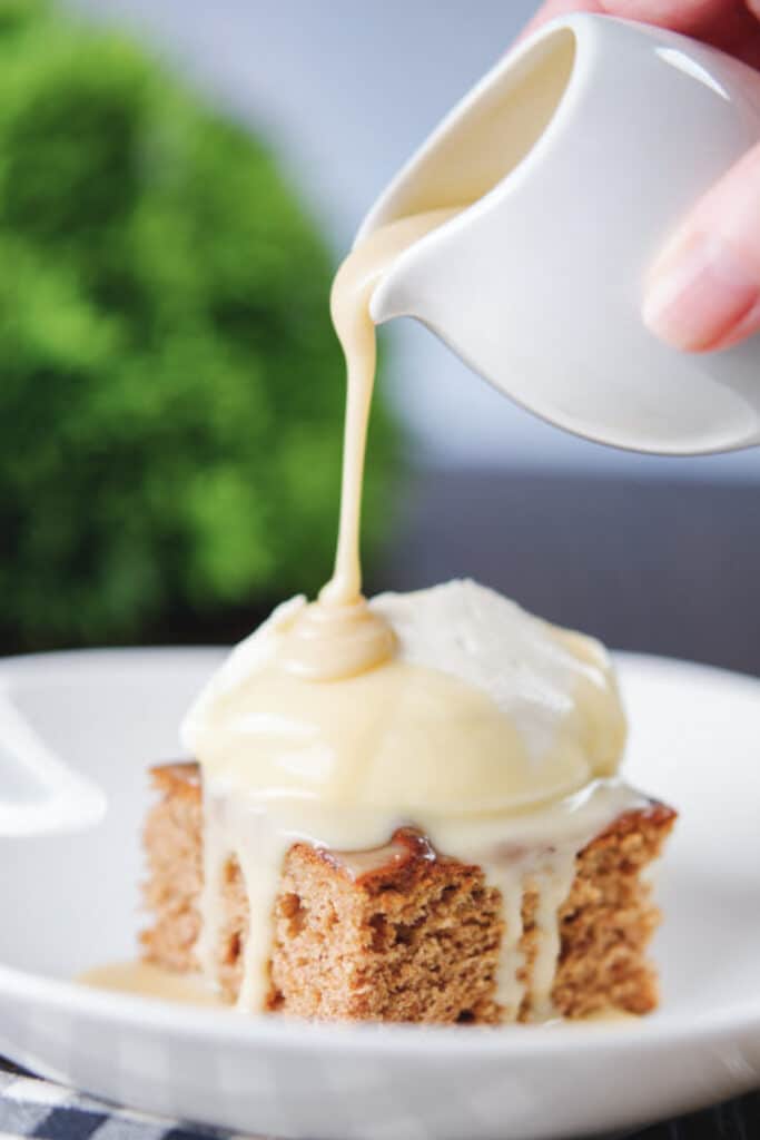 Pouring sauce on the pudding cake.