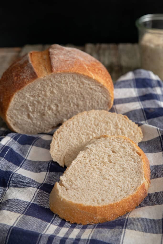 Bread on a napkin with two slices cut.